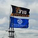 Grand Valley State University (GVSU) and Florida International University (FIU) flags wave in the air.